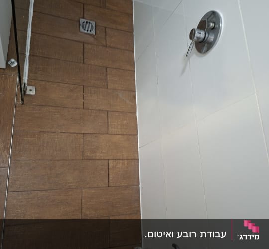 מקלחת עם אריחים חומים וברז כסוף